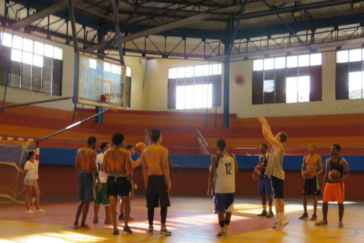 Scott Csaplar playing basketball with his teammates at the gym in Havana.
